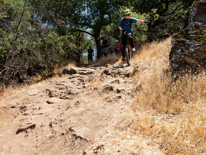 Mountain unicyclist near the top of rocky, dry section of trail.